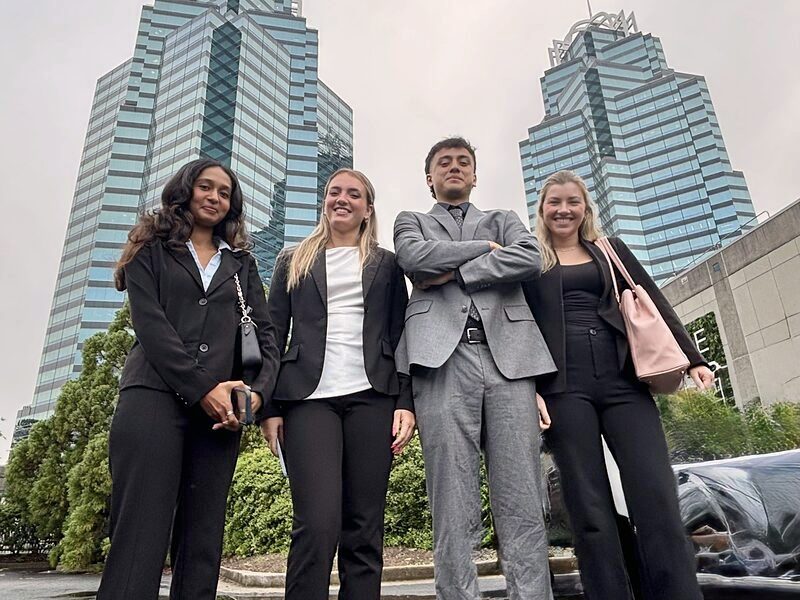 Four Palmora team members outside the Charlotte office towers