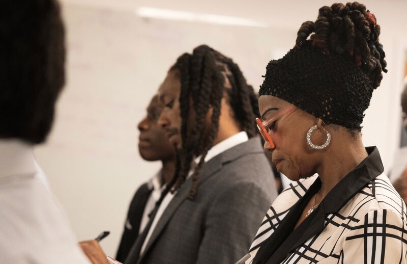 Palmora team members taking notes together during a training session