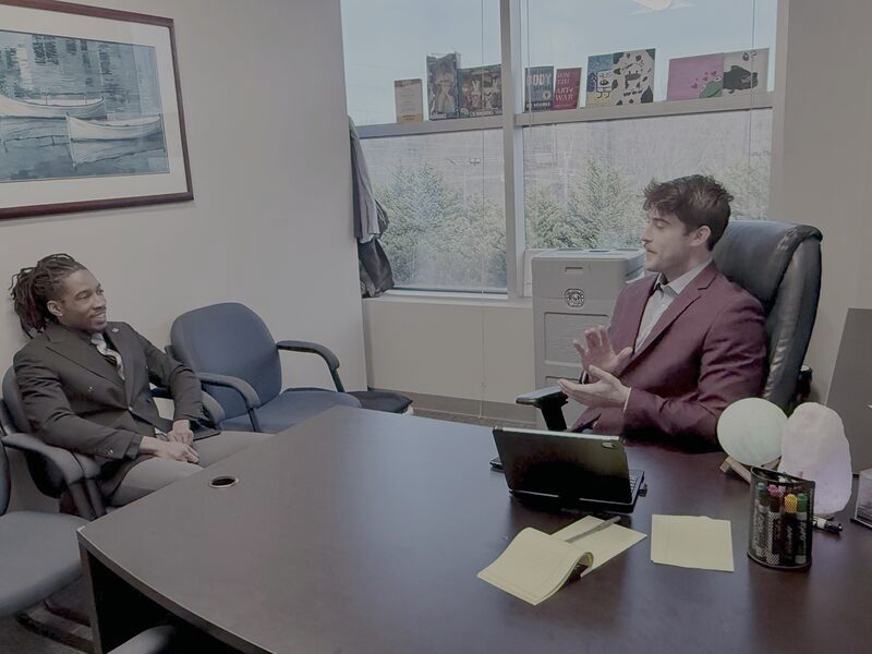 A Palmora trainer working through a session with a team member at the conference table
