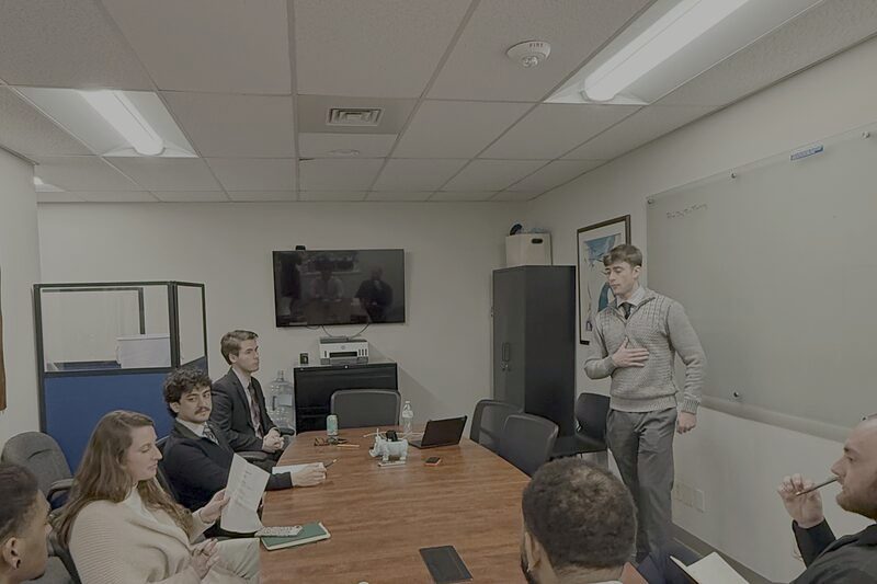 A Palmora team meeting, with a colleague presenting at the whiteboard
