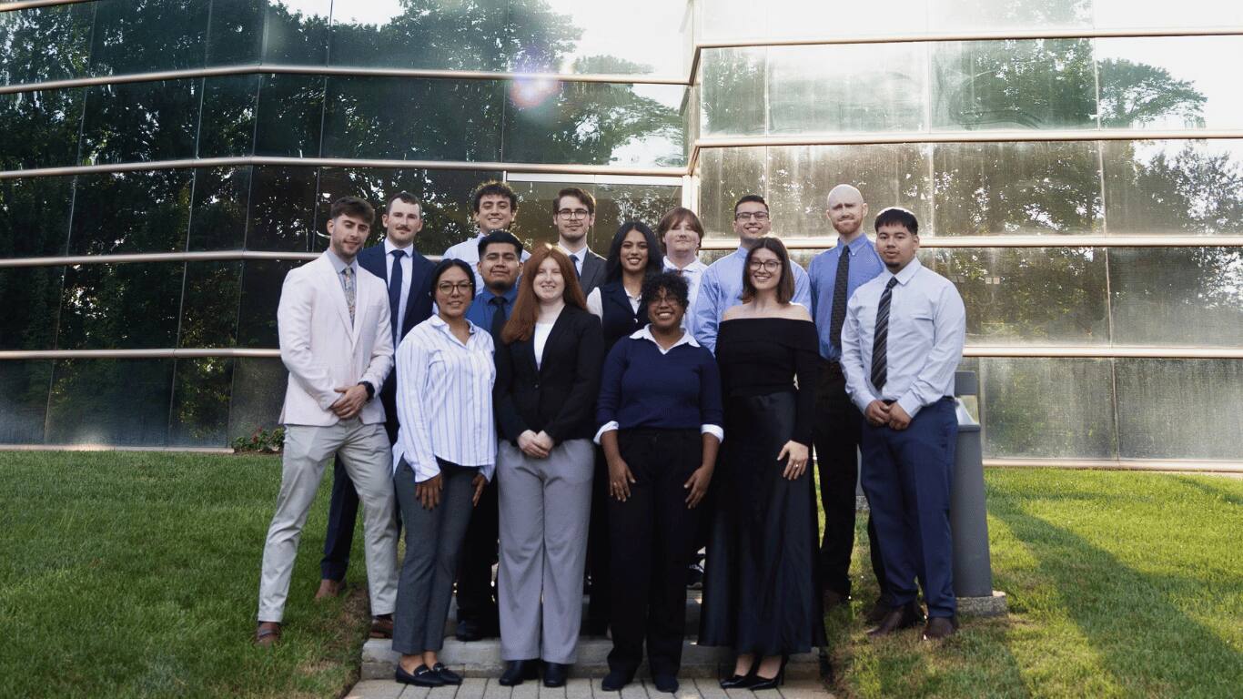 The Palmora team standing together outside their Charlotte office