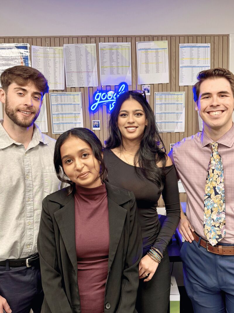 Four Palmora team members smiling together in the office